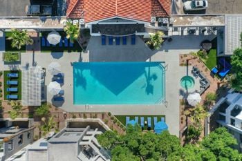 A birds eye view of a resort with a swimming pool